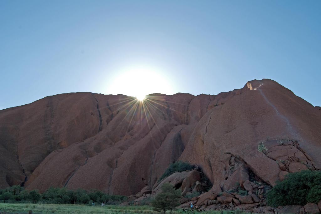 Sun peaking over Uluru